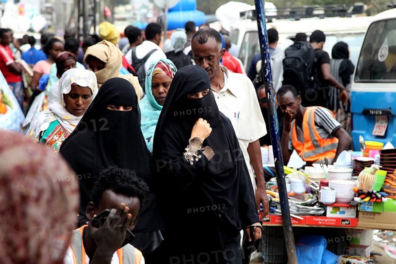 Veiled woman in a busy marketplace in Addis Ababa, Addis Ababa, Ethiopia