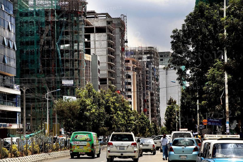 Urban street with trees flanked by modern buildings, Addis Ababa, Ethiopia