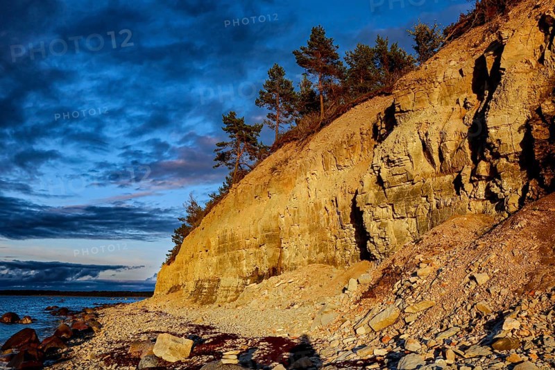 Atmospheric cliffs at sunset with rocks and trees, Panga, Saaremaa, Estonia