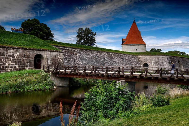 Medieval castle with bridge and moat surrounded by green countryside, Kuressaare, Saaremaa, Estonia
