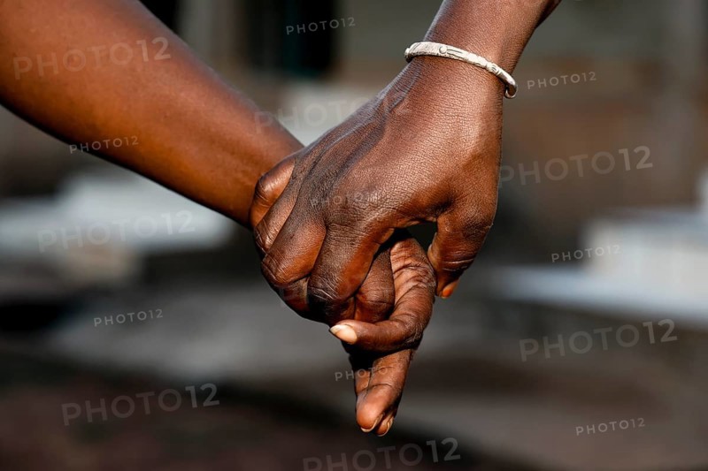 Employee holding a patient's hand at Centre Jubile, Korhogo, null, Côte d'Ivoire