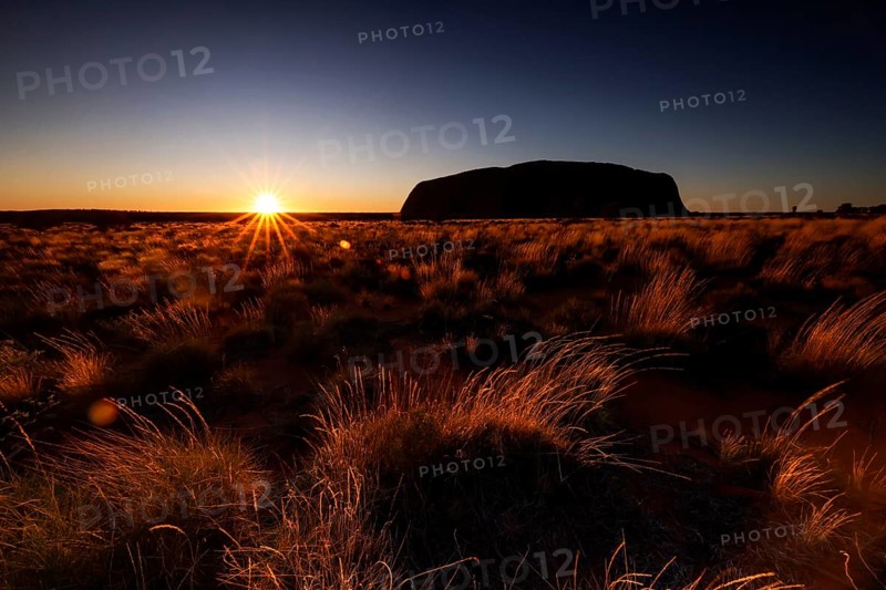 Uluru at sunrise with glowing sky in the Australian outback, Uluru, Northern Territory, Australia