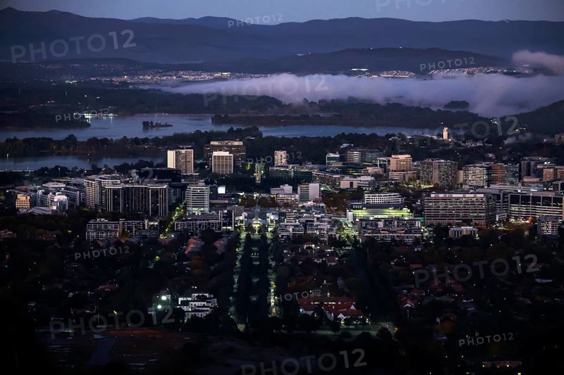 Nighttime view from Mount Ainslie Lookout of Canberra's illuminated CBD at dusk, Canberra, Australian Capital Territory, Australia