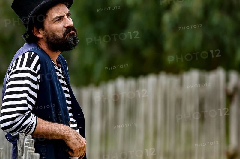 A performer wearing traditional dress looks seriously into the distance, Ballarat, Australia