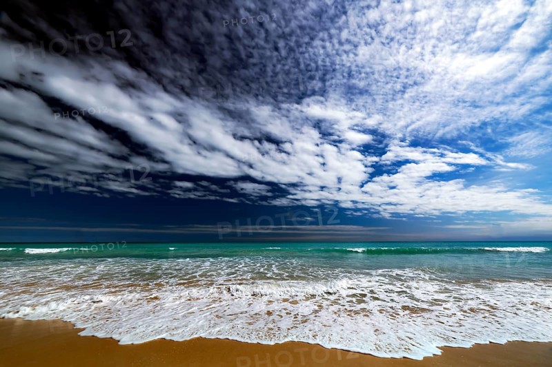 Dynamic cloud formations over the turquoise water of Cable Beach, Broome, Western Australia, Australia