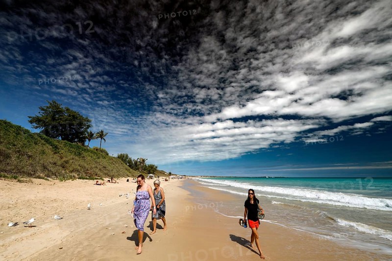 Group of people walking along sunny Cable Beach, Broome, Western Australia, Australia
