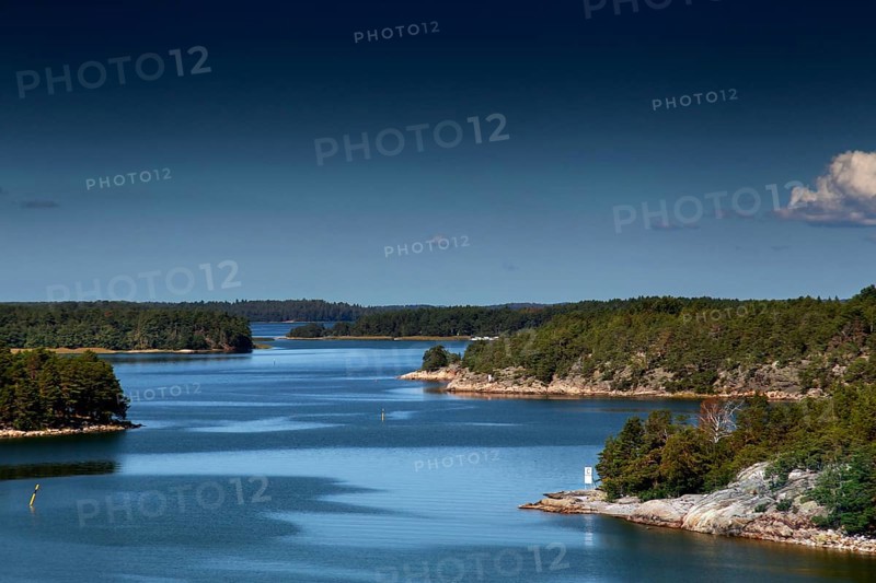 Tranquil view of an archipelago with numerous islands under clear skies