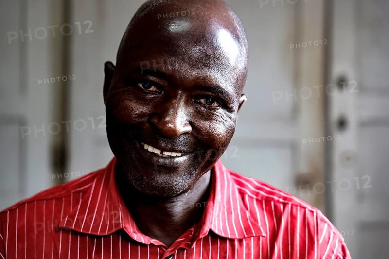 Smiling employee named Honoré in a men's psychiatric ward in Bouaké, Bouaké, Nimbo, Côte d'Ivoire