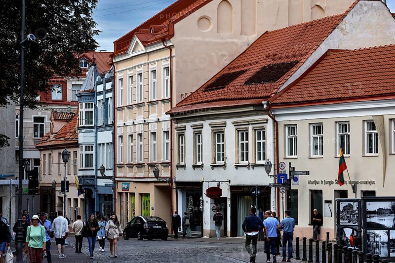 Architecture of an old town street with pedestrians in Vilnius under cloudy sky, Vilnius, Vilnius County, Lithuania