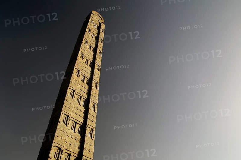 A tall, impressive stele rises majestically against the clear sky, Axum, Tigray, Ethiopia