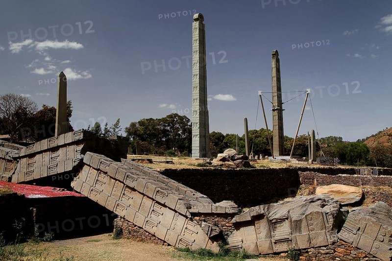 Collapsed and standing steles in Axum's Stele Park under clear skies, Axum, Tigray, Ethiopia