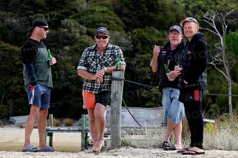 Male group standing on the beach of the Abel Tasman Coast Track, Torrent Bay, Abel Tasman National Park, New Zealand