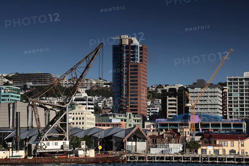 Industrial crane next to modern urban architecture on Wellington Waterfront, Wellington, New Zealand