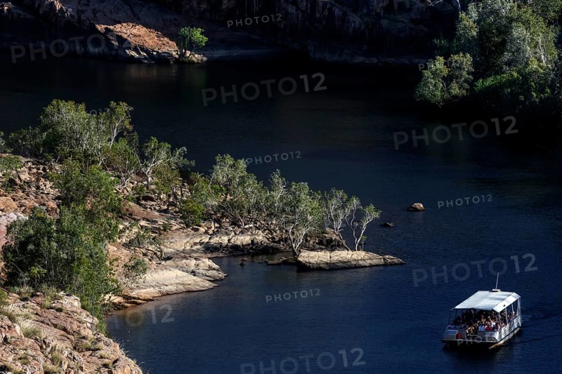 Boating on calm river between rocky landscape at Pat's Lookout in Nitmiluk National Park, Nitmiluk National Park, Northern Territory, Australia