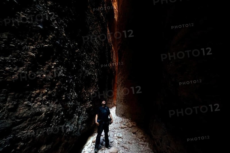 Narrow path through the high, shady walls of Echidna Chasm in Purnululu National Park, Purnululu National Park, Western Australia, Australia