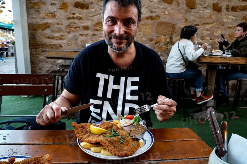 A man enjoying a schnitzel in a German restaurant in Hahndorf, Hahndorf, South Australia, Australia