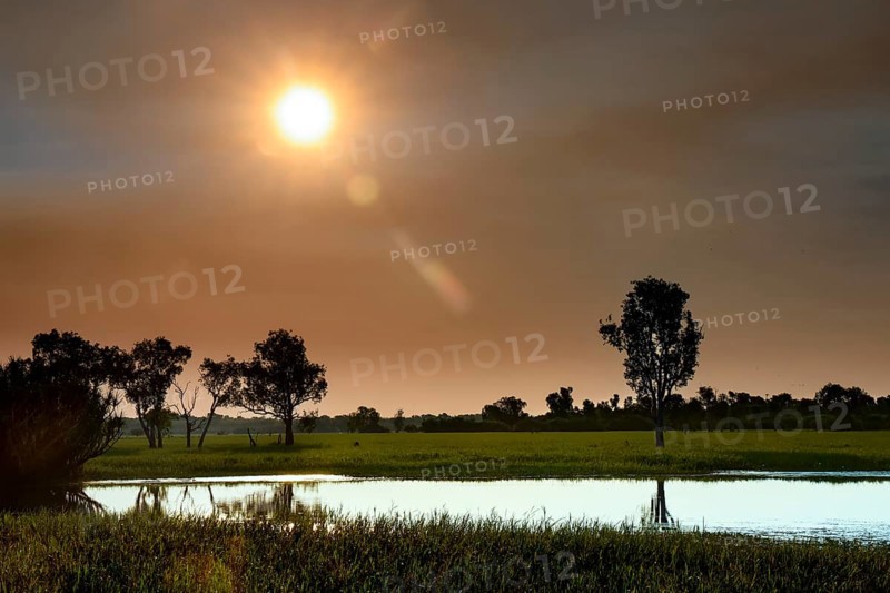 Idyllic sunset scene over Yellow Waters, Kakadu National Park, with reflecting water, Yellow Water, Northern Territory, Australia