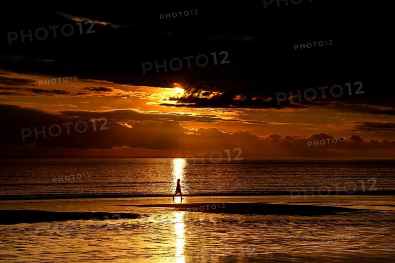 Golden sunset on Cable Beach with heavenly reflections in water, Broome, Western Australia, Australia