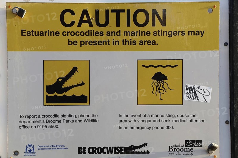 Warning sign on Cable Beach warns of crocodiles and jellyfish in the area, Broome, Western Australia, Australia