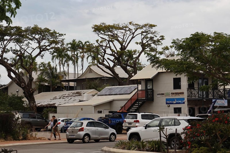 Building with parked cars and trees on Carnarvon Street, Broome, Western Australia, Australia