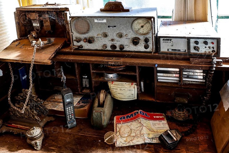 Antique radio on a table with maps and old devices, zero