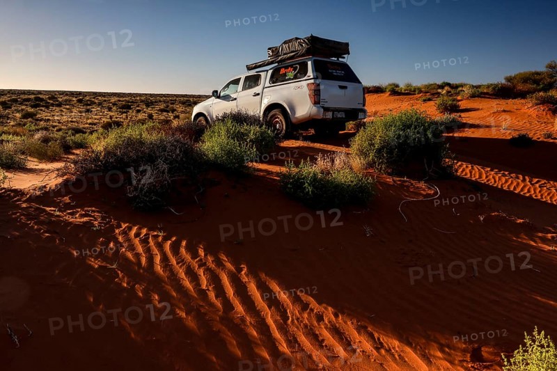Off-road vehicle drives over sandy dunes in Simpson Desert, Simpson Desert, Australia