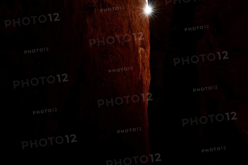 Dark rocky gorge with narrow beam of light in Standley Chasm, zero