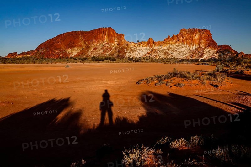 Dark shadows against the contrasting landscape of Rainbow Valley when the sun is low, Rainbow Valley, Northern Territory, Australia