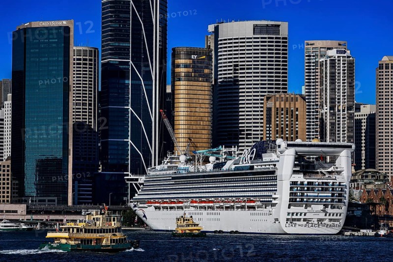 Large cruise ship in harbor in front of the impressive skyline of Sydney, Sydney, New South Wales, Australia