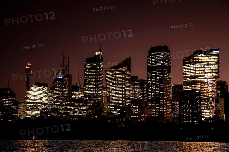 Sydney skyline illuminated at night with reflecting lights on skyscrapers, Sydney, New South Wales, Australia