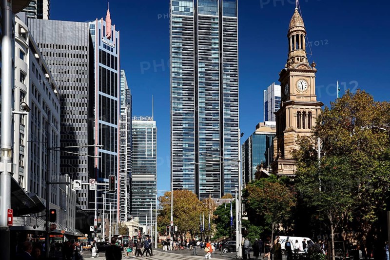 Modern skyscrapers next to historic City Hall under clear blue skies, Sydney, New South Wales, Australia
