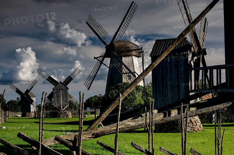 Traditional windmills in a green landscape with dramatic clouds, Angla, Saaremaa, Estonia