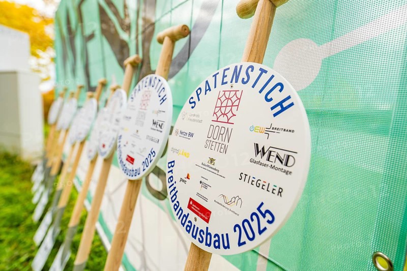Several signs printed with logos announcing broadband expansion in 2025, fiberglass groundbreaking, Dornstetten, Freudenstadt, Germany