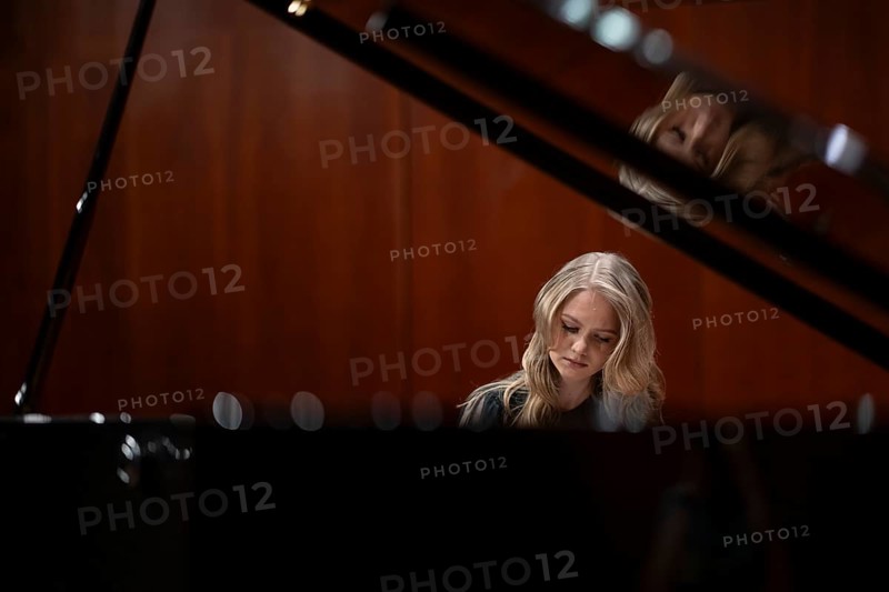Young woman, pianist, with concentrated facial expression playing on a Steinway & Sons grand piano, Stuttgart, Baden-Württemberg, Germany