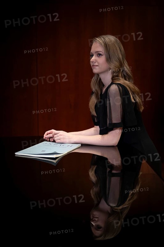 Young woman, pianist, in evening dress, with notes by Johann Sebastian Bach, supported on Steinway & Sons grand piano, Stuttgart, Baden-Württemberg, Germany