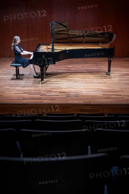 Young woman, pianist, in evening dress, in a concert hall, playing on a Steinway & Sons grand piano, Stuttgart, Baden-Württemberg, Germany