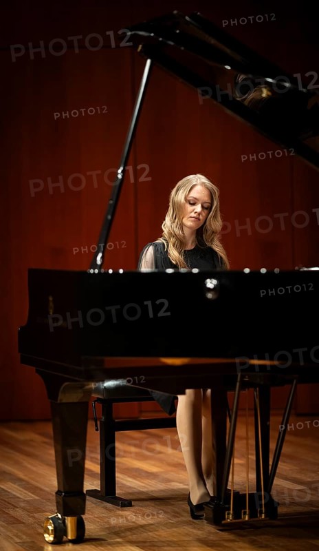 Young woman, pianist, with concentrated facial expression in a concert hall playing a Steinway & Sons grand piano, Stuttgart, Baden-Württemberg, Germany