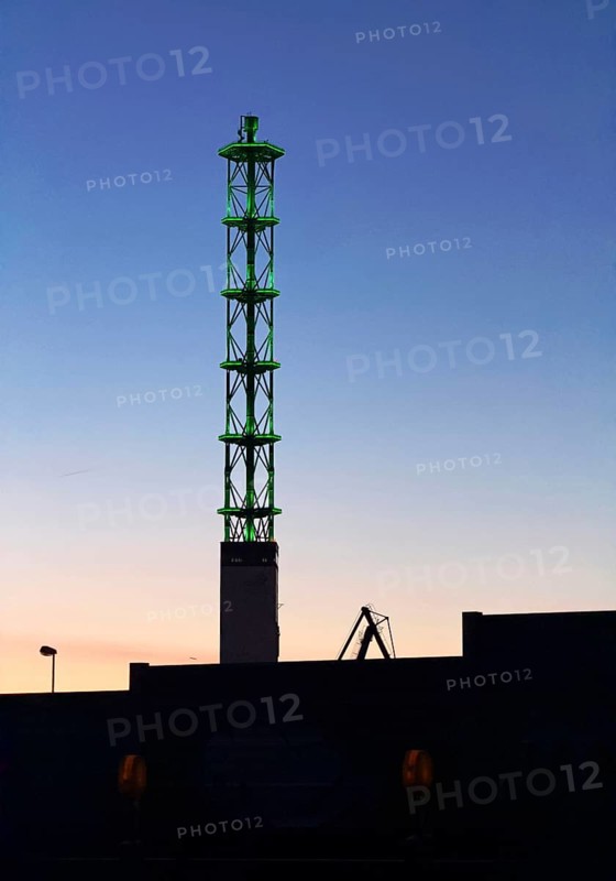 Illuminated municipal utility tower of Stadtwerke Duisburg at dusk, Duisburg, Ruhr area, North Rhine-Westphalia, Germany