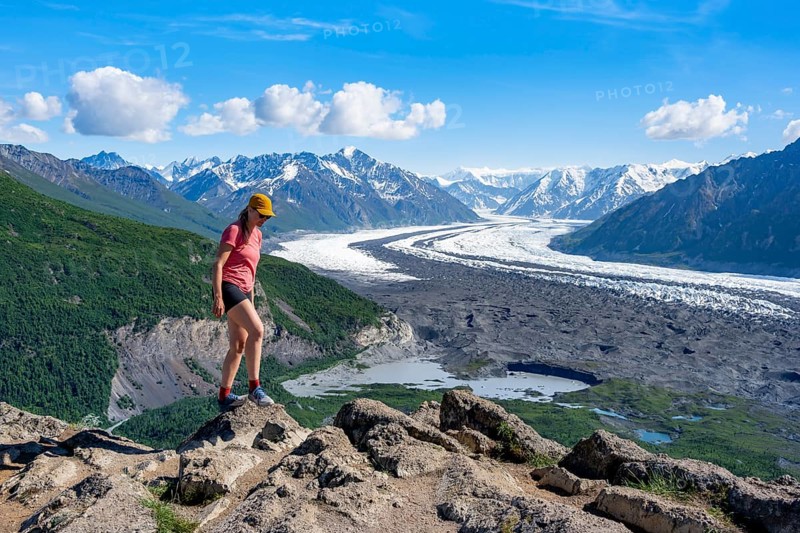Young woman enjoying the view, view of impressive mountain landscape with Matanuska glacier and glaciated mountain peaks, Lion's Head, Chugach Mountains, Alaska, USA