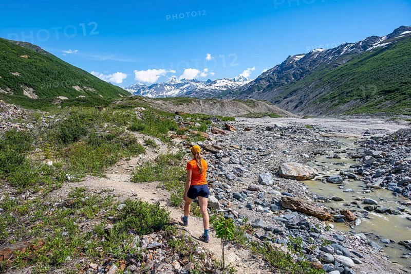Tourist on a hiking trail along the Miller Creek River at Castner Glacier, Delta Range, Alaska Range, Richardson Highway, Alaska, USA