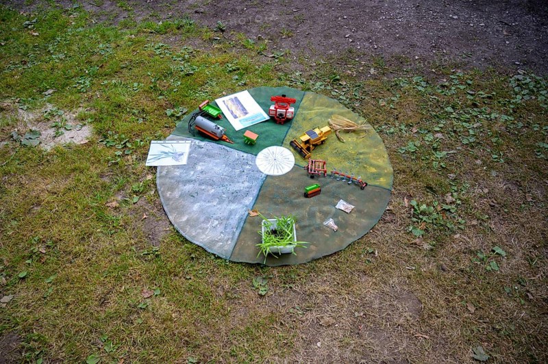 Circular outdoor table with toy vehicles on a grassy area, playful presentation of the individual months in the agricultural year, event for schoolchildren of the campaign Create transparency, Osnabrücker Land, Lower Saxony, Germany