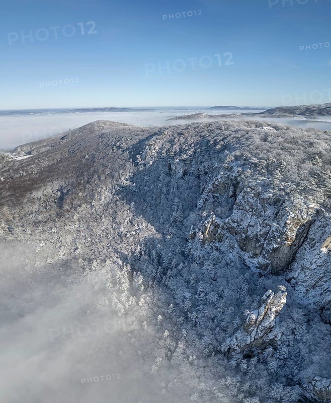 Aerial view of snowy stone walls and fog in the valley, Schwarzensee, Weissenbach an der Triesting, Lower Austria, Austria