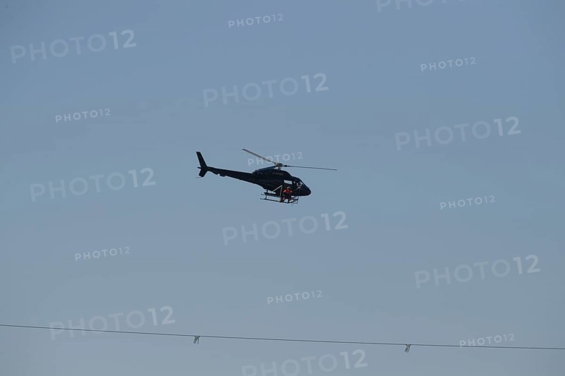 A helicopter over a rope in the sky in twilight conditions, Lemförde, Lower Saxony, Germany