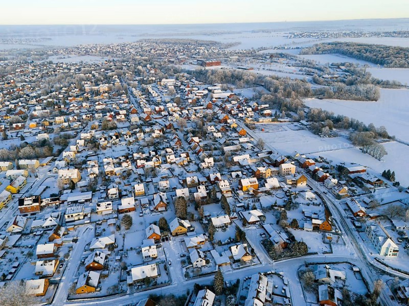 Winter aerial view of a village with snowy houses and landscapes in the background, Aerial view, Oelsburg, Ilsede, Peine District, Lower Saxony, Germany