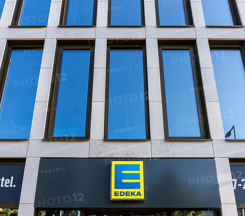 Yellow-blue Edeka company logo on a new building on Invalidenstraße in Mitte, Berlin, Germany
