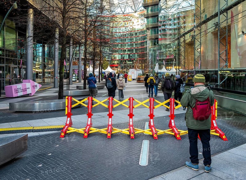 Massive metal access barriers in red and yellow at Center Potsdamer Platz, Berlin, Germany