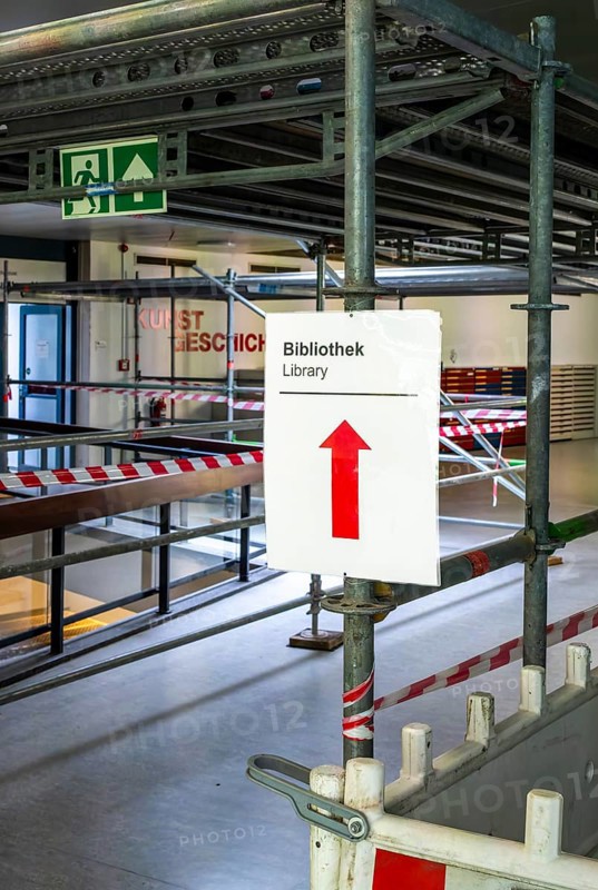 Technical University in Berlin, provisional information sheets and signs at an indoor construction site show the way towards the library, Berlin, Germany