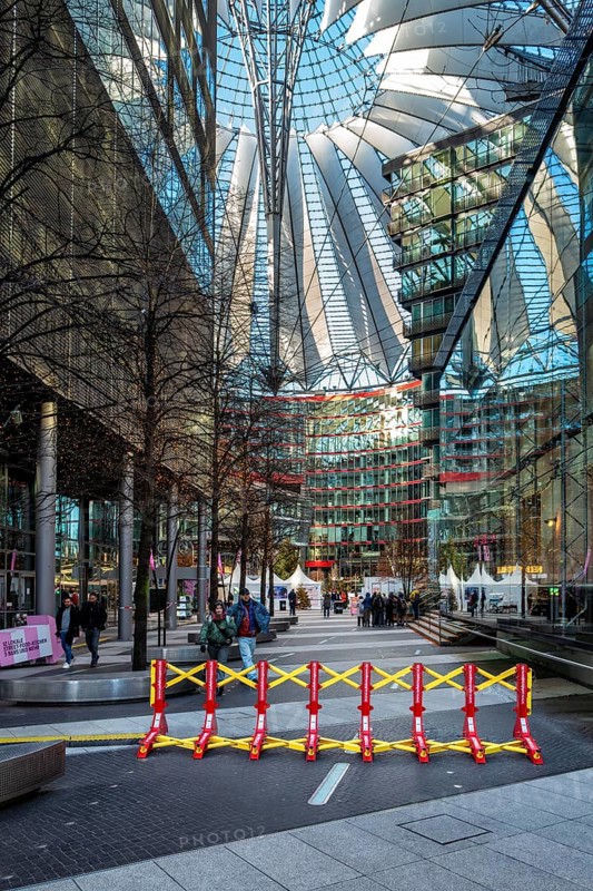 Massive metal access barriers in red and yellow at Center Potsdamer Platz, Berlin, Germany
