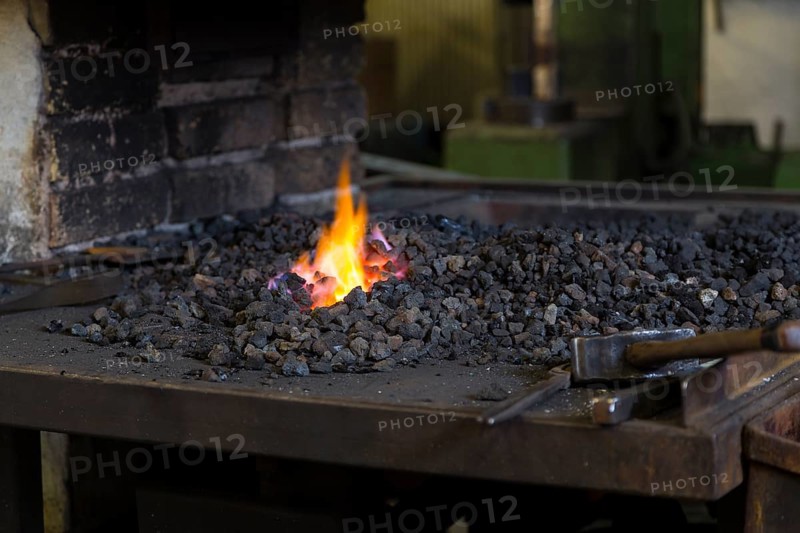 A blacksmith forging, working at the Ehnert forge in Dresden-Bühlau, Saxony, Germany