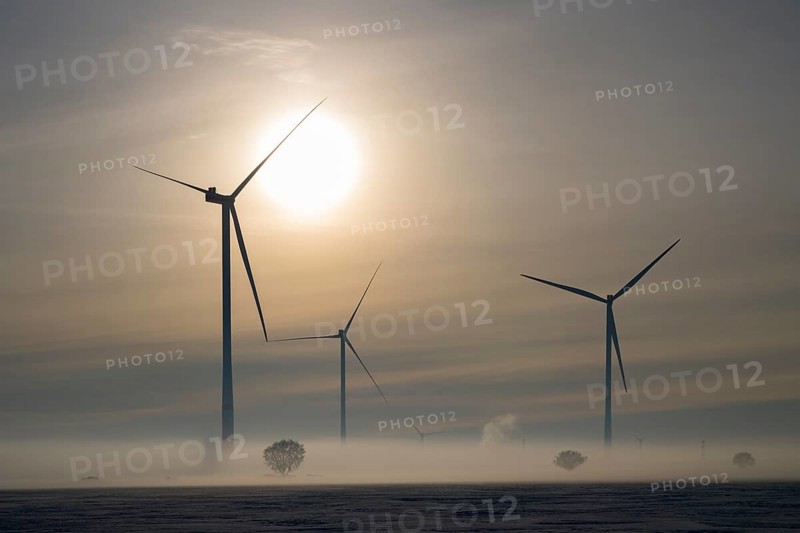 Wind turbines stand in fog under a dramatic sky at sunset, wind turbines between Solschen and Adenstedt, Ilsede, Peine district, Lower Saxony, Germany